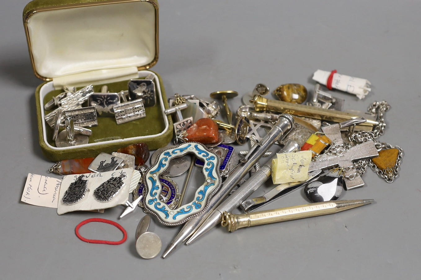 A group of mixed items including quartz pendants, a sterling and enamel brooch, 68mm, assorted pairs of cufflinks, medallions and four pens including Sampson Mordan, hallmarked for London, 1932.
